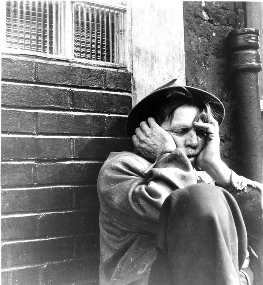 On The Bowery man hands on face 1000x1085
